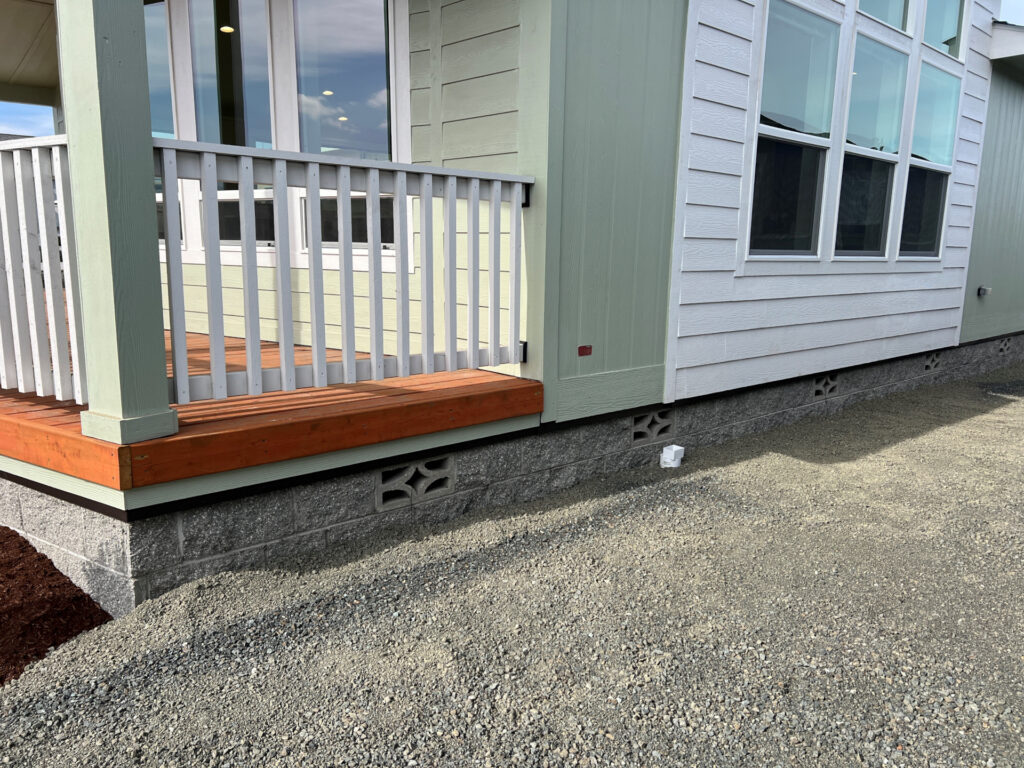 CMU skirting on a manufactured home with a gravel backfill