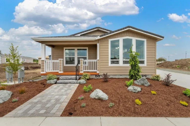 Landscaped manufactured home with a paver walkway