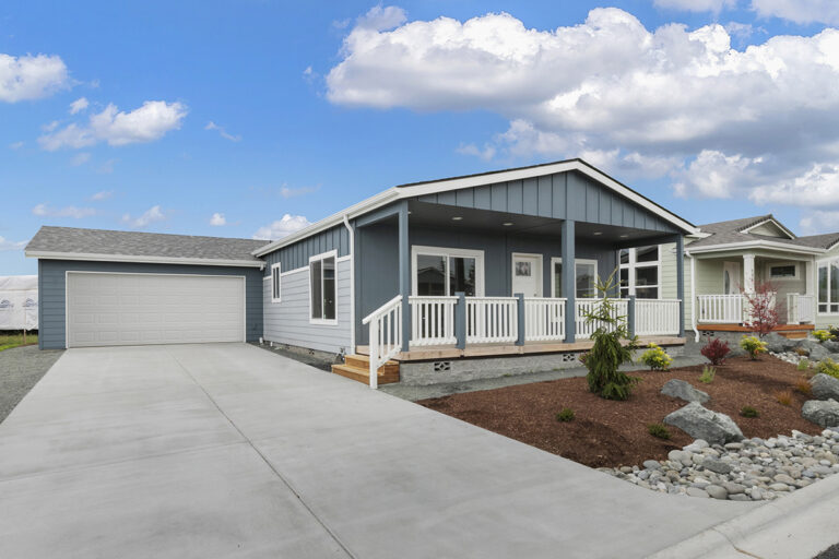 Blue manufactured home with an attached garage