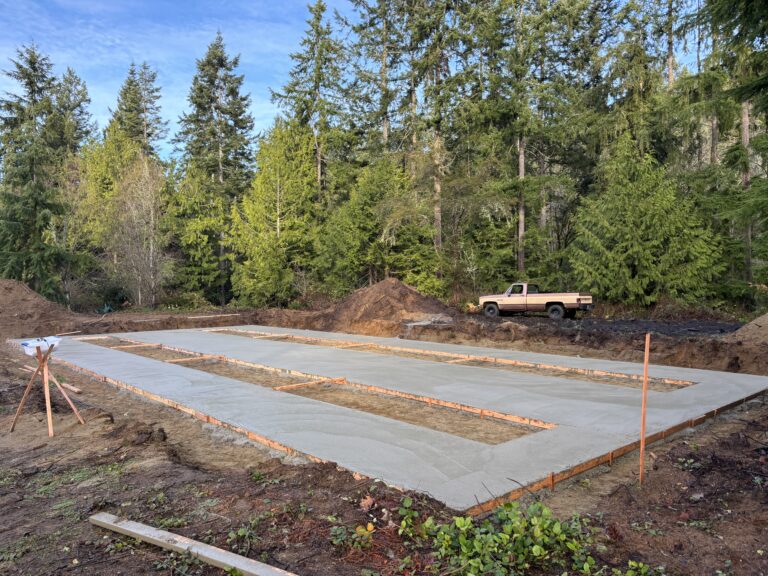 Concrete slab foundation for a pit set manufactured home