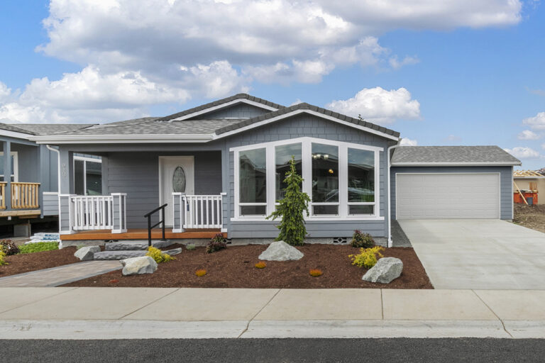 Blue manufactured home with a color-matched attached garage in Sequim, WA