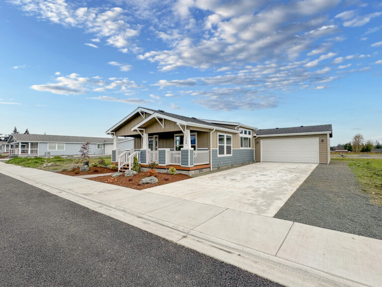 Craftsman manufactured home with an attached two-car garage and concrete driveway