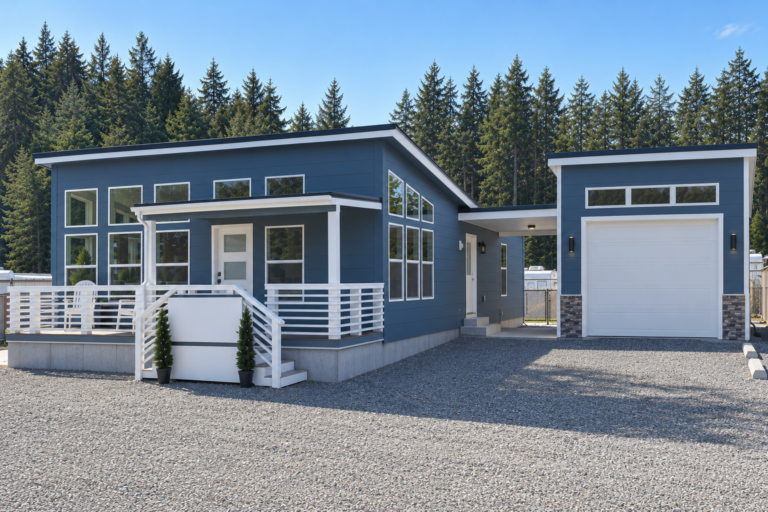 Blue modern manufactured home with a matching detached garage and covered breezeway