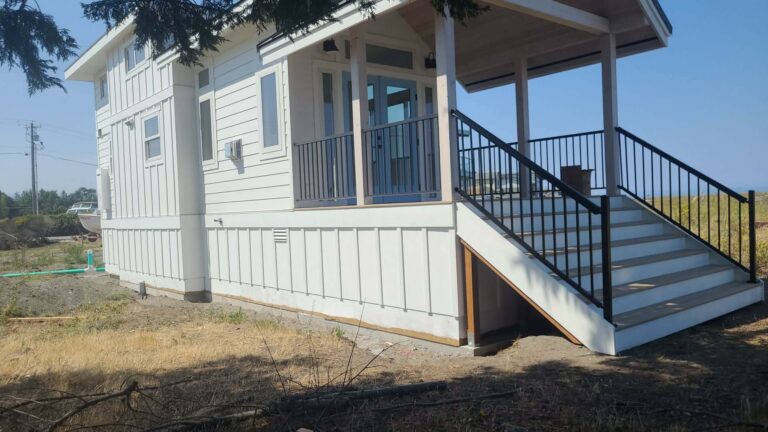 Ground set manufactured home sitting above grade with elevated stairs
